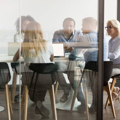 Diverse,Businesspeople,Sit,At,Office,Desk,Brainstorm,Together,Discuss,Project